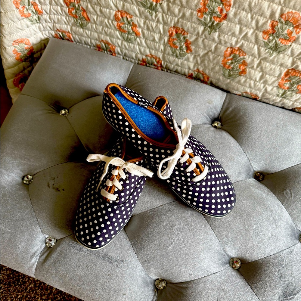 Navy blue Keds with white polka dots.